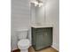 Well-lit powder room features a vanity with fixtures and a toilet at 140 Rolison Way, Fayetteville, GA 30214