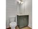 Well-lit powder room with shiplap accent wall and modern fixtures at 140 Rolison Way, Fayetteville, GA 30214