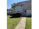 Charming townhome featuring a cozy front yard with mature landscaping and a welcoming entrance gate at 296 Country Club Dr, Jonesboro, GA 30238