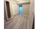 Hallway with wood-look floors, coat closet, and easy access to other rooms at 296 Country Club Dr, Jonesboro, GA 30238