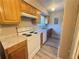 Kitchen featuring white appliances, wood cabinets, and gray countertops at 296 Country Club Dr, Jonesboro, GA 30238