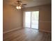 Bright living room featuring luxury vinyl floors, a ceiling fan, and slider doors at 296 Country Club Dr, Jonesboro, GA 30238