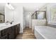 Bathroom featuring dual sinks, walk-in shower, and soaking tub at 3020 Westgate Park Dr, Loganville, GA 30052