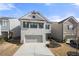 Charming two-story home with gray brick, a two-car garage, and manicured landscaping at 3020 Westgate Park Dr, Loganville, GA 30052