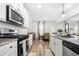 Bright kitchen and eat-in nook featuring granite counters, stainless steel appliances, and white cabinetry at 3020 Westgate Park Dr, Loganville, GA 30052