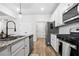Bright kitchen featuring granite counters, stainless steel appliances, and white cabinetry at 3020 Westgate Park Dr, Loganville, GA 30052
