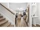 Open-concept living room with stairs, featuring a fireplace and modern decor at 3020 Westgate Park Dr, Loganville, GA 30052