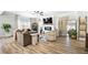 Bright living room featuring hardwood floors, a ceiling fan, and modern furniture at 3020 Westgate Park Dr, Loganville, GA 30052