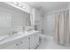 Bathroom featuring double sink vanity with marble counters and a shower/tub combo at 4161 Sherwood Oaks Dr, Decatur, GA 30034