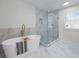 Beautiful bathroom features soaking tub, glass shower, and marble flooring at 4161 Sherwood Oaks Dr, Decatur, GA 30034