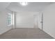 Spacious, neutral bedroom with carpet flooring and natural light from the window and an open door at 4161 Sherwood Oaks Dr, Decatur, GA 30034