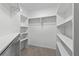 Walk-in closet provides ample storage with built-in shelving and rods for organizing clothes at 4161 Sherwood Oaks Dr, Decatur, GA 30034