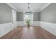 Elegant dining room with hardwood floors, wainscoting and a modern chandelier at 4161 Sherwood Oaks Dr, Decatur, GA 30034