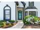 Close up of the home's entrance featuring a blue door, beautiful shrubbery, and an inviting walkway at 4161 Sherwood Oaks Dr, Decatur, GA 30034