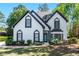 Charming two-story home featuring a well-manicured lawn and beautiful landscaping around the front of the house at 4161 Sherwood Oaks Dr, Decatur, GA 30034