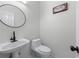 Clean half bathroom features a sleek sink, toilet, and a decorative sign at 4161 Sherwood Oaks Dr, Decatur, GA 30034