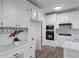 Bright kitchen with white cabinets, stainless steel appliances, and ample counter space for cooking at 4161 Sherwood Oaks Dr, Decatur, GA 30034