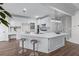 Spacious kitchen features an island with barstool seating, custom cabinets, stone countertops, and a modern light fixture at 4161 Sherwood Oaks Dr, Decatur, GA 30034