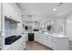 Bright kitchen features white cabinets, stainless appliances, stone countertops and backsplash, and an open floor plan at 4161 Sherwood Oaks Dr, Decatur, GA 30034