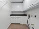 Functional laundry room with storage cabinets, counter space, and essential utility connections at 4161 Sherwood Oaks Dr, Decatur, GA 30034