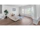 Bright living room with hardwood floors, large windows, comfortable seating and decorative columns at 4161 Sherwood Oaks Dr, Decatur, GA 30034