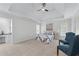 Spacious main bedroom with a tray ceiling, carpeting, and sitting area with blue accent chairs at 4161 Sherwood Oaks Dr, Decatur, GA 30034