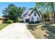 Beautiful side view of home, with a long driveway leading to the garage, and manicured landscaping at 4161 Sherwood Oaks Dr, Decatur, GA 30034