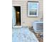Backyard features concrete patio and access to the property interior with light-colored vinyl siding and a window at 164 Haven Oak Way, Lawrenceville, GA 30044