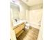 Modern bathroom featuring a sleek vanity, stylish fixtures, and a shower-tub combo at 164 Haven Oak Way, Lawrenceville, GA 30044