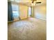 Large bedroom with natural light, neutral walls, and a ceiling fan at 164 Haven Oak Way, Lawrenceville, GA 30044