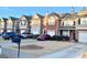 An exterior view showcasing the row of townhomes, each with unique architectural details at 164 Haven Oak Way, Lawrenceville, GA 30044