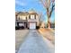 Charming two-story townhome with a driveway and attached garage at 164 Haven Oak Way, Lawrenceville, GA 30044