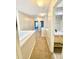 Well-lit hallway leading to a full bathroom with modern vanity and fixtures, creating a functional and stylish space at 164 Haven Oak Way, Lawrenceville, GA 30044