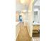 Well-lit hallway leading to a full bathroom with modern vanity and fixtures, creating a functional and stylish space at 164 Haven Oak Way, Lawrenceville, GA 30044