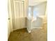 Hallway featuring neutral paint, and carpet that provides access to various rooms, enhancing the functionality of the house at 164 Haven Oak Way, Lawrenceville, GA 30044