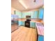 Efficient kitchen with stainless steel refrigerator, range, and blue cabinets, complete with modern appliances and lots of counterspace at 164 Haven Oak Way, Lawrenceville, GA 30044