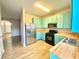 Bright kitchen featuring stainless steel appliances, light blue cabinets, and butcher block countertops at 164 Haven Oak Way, Lawrenceville, GA 30044