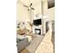 Bright living room with ceiling fan, fireplace, large screen TV, and wood flooring at 164 Haven Oak Way, Lawrenceville, GA 30044