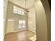 Spacious living room with high ceilings, large windows, and a ceiling fan at 164 Haven Oak Way, Lawrenceville, GA 30044