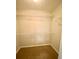 Spacious walk-in closet provides ample storage with adjustable shelving and neutral carpet at 164 Haven Oak Way, Lawrenceville, GA 30044