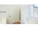 Well-lit bathroom featuring a shower, tub, window and modern finishes at 4032 Robin Cir, College Park, GA 30349