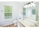 Well-lit bathroom featuring a double sink vanity, ample natural light, and a soaking tub at 4032 Robin Cir, College Park, GA 30349