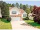 Beautiful two-story home highlighting stone accents, a two-car garage, and a green lawn at 4032 Robin Cir, College Park, GA 30349