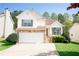 Charming two-story home featuring stone accents, a two-car garage, and a well-manicured lawn at 4032 Robin Cir, College Park, GA 30349