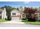 Inviting two-story home with stone accents, a two-car garage, and mature trees at 4032 Robin Cir, College Park, GA 30349