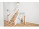 Bright staircase with wood banisters and seamless flooring leads to the upper level at 4032 Robin Cir, College Park, GA 30349