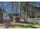 Backyard featuring a unique two-story wooden playset surrounded by a well-maintained lawn and a wooden fence at 5000 Bainbridge Sw Ct, Lilburn, GA 30047