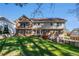 The backyard boasts a well-manicured lawn and the multi-level brick-and-siding exterior of the home at 5000 Bainbridge Sw Ct, Lilburn, GA 30047
