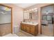 Bathroom featuring double sinks, ample lighting, and vintage cabinets at 5000 Bainbridge Sw Ct, Lilburn, GA 30047