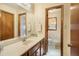 Bathroom with a single sink vanity, patterned floors, and walk-in shower at 5000 Bainbridge Sw Ct, Lilburn, GA 30047